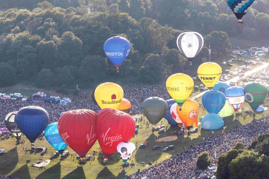 Hot air balloons taking off from a field